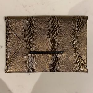 BCBG metallic gold “snakeskin” envelope clutch